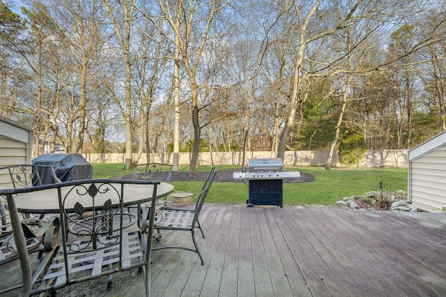 deck with a lawn and area for grilling