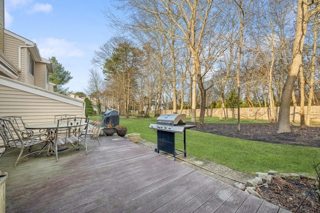 deck with area for grilling and a lawn