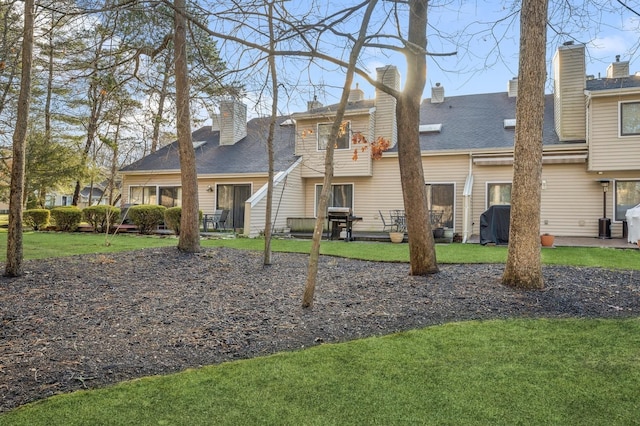 rear view of house with a lawn