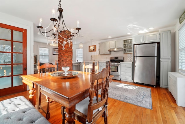 dining room featuring light hardwood / wood-style floors and a chandelier