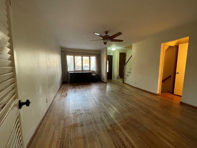 empty room featuring ceiling fan and hardwood / wood-style floors