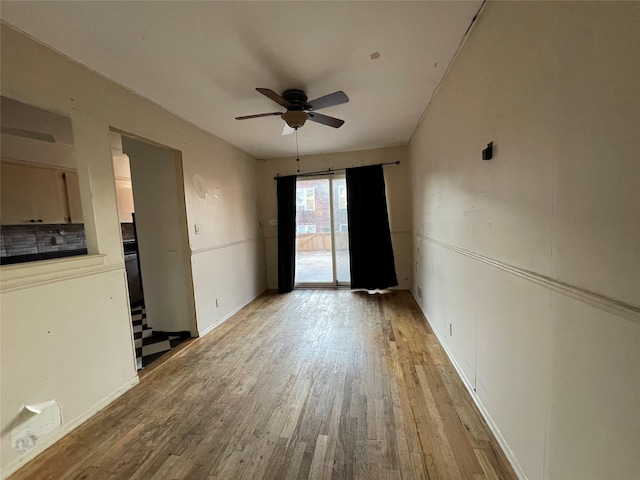 spare room featuring ceiling fan and light hardwood / wood-style flooring