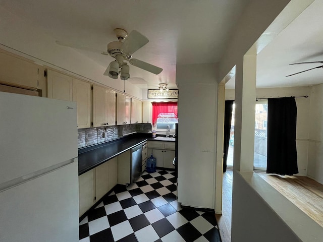 kitchen with ceiling fan, sink, stainless steel dishwasher, white fridge, and decorative backsplash