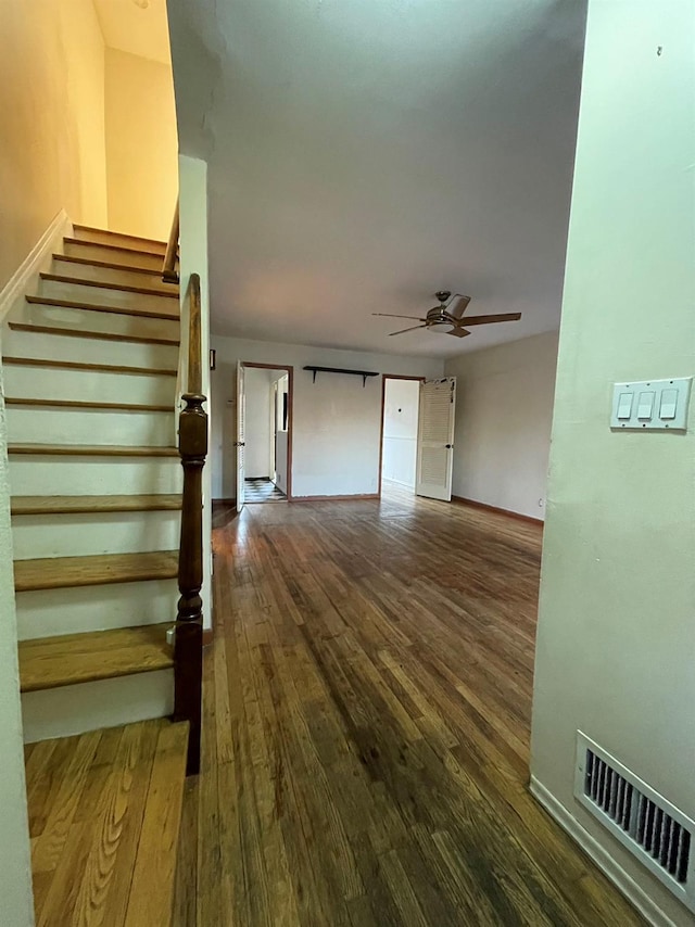 interior space with wood-type flooring and ceiling fan