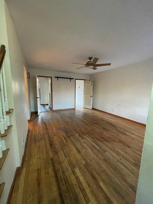 interior space with dark hardwood / wood-style floors and ceiling fan