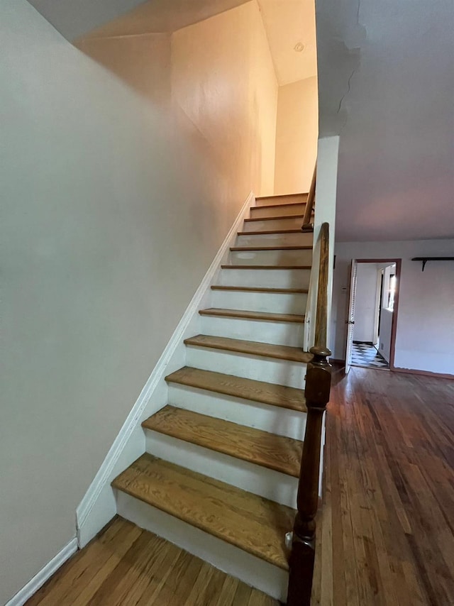 stairway featuring wood-type flooring