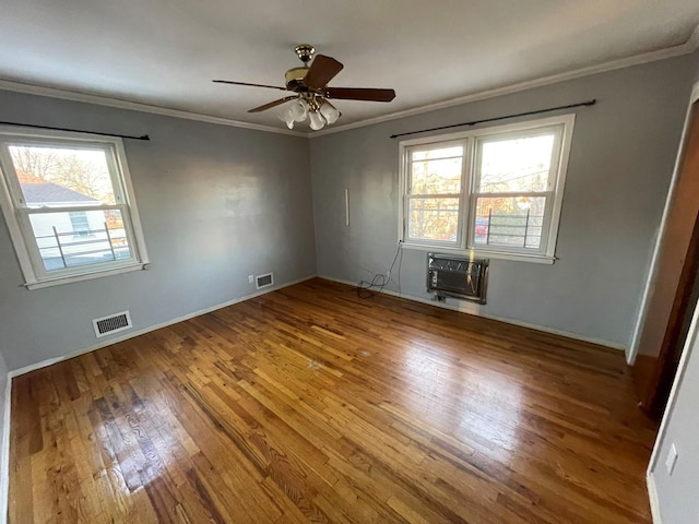 unfurnished room with crown molding, hardwood / wood-style floors, ceiling fan, and a wall mounted air conditioner