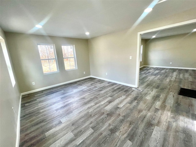 empty room with dark wood-type flooring