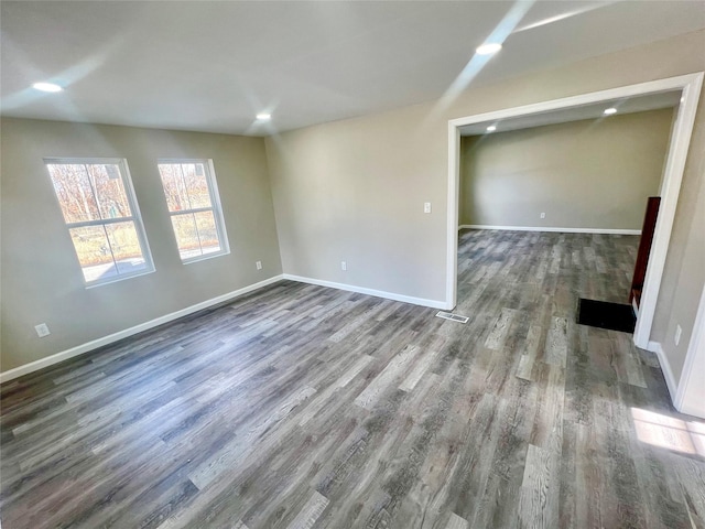 empty room with dark hardwood / wood-style floors