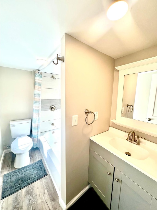 full bathroom with vanity, hardwood / wood-style floors, shower / bathtub combination with curtain, and toilet