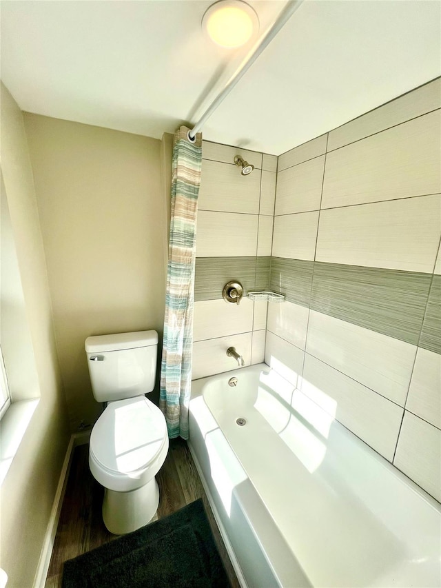 bathroom with hardwood / wood-style flooring, shower / tub combo with curtain, and toilet