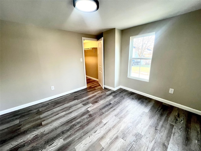 spare room with dark hardwood / wood-style floors