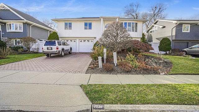 split foyer home with a front yard and a garage