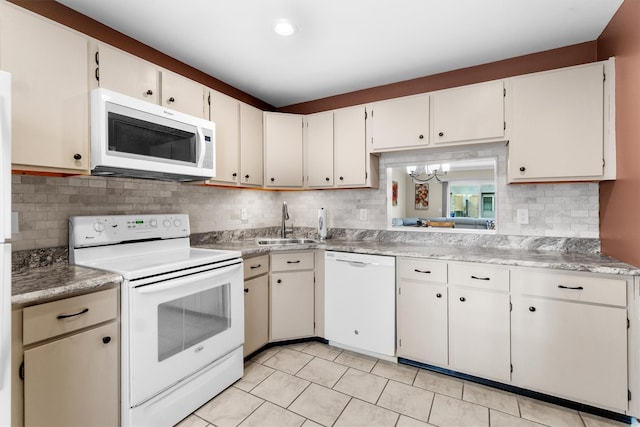 kitchen featuring white appliances, sink, a notable chandelier, light tile patterned flooring, and white cabinetry