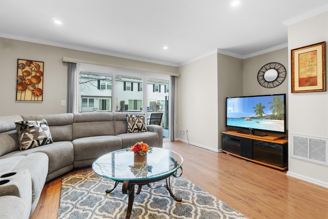 living room with light hardwood / wood-style floors and ornamental molding