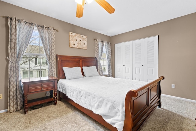 carpeted bedroom with ceiling fan and a closet