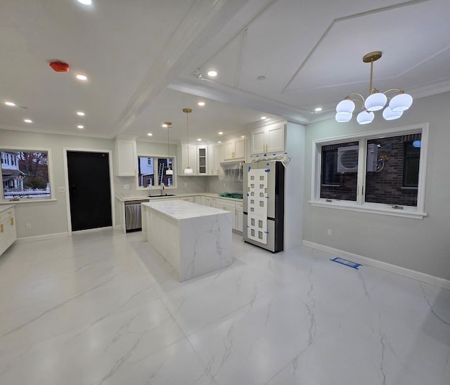 kitchen featuring appliances with stainless steel finishes, sink, pendant lighting, white cabinets, and a kitchen island