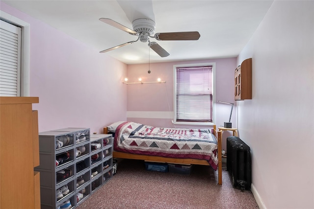 bedroom with ceiling fan, radiator heating unit, and carpet floors