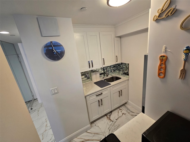 bathroom featuring backsplash, vanity, and ornamental molding