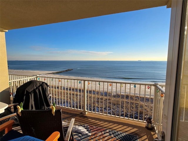 balcony featuring a water view and a view of the beach