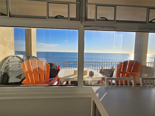 sunroom featuring plenty of natural light and a water view