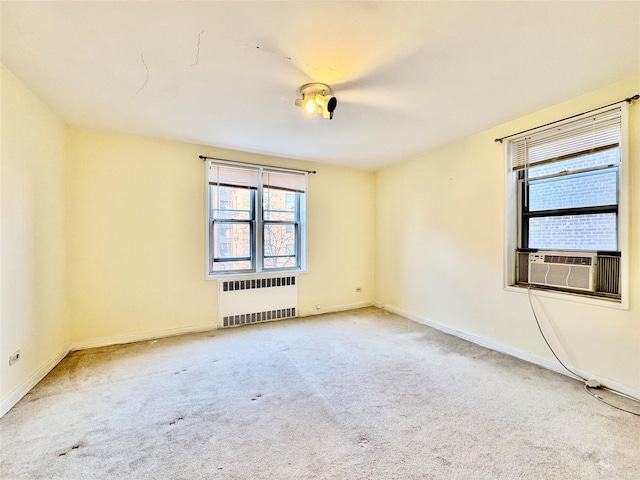 unfurnished room with carpet, radiator, and cooling unit