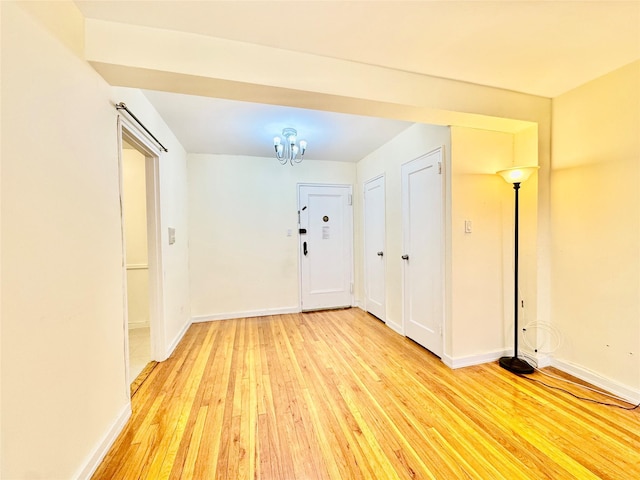 foyer featuring a chandelier and light wood-type flooring