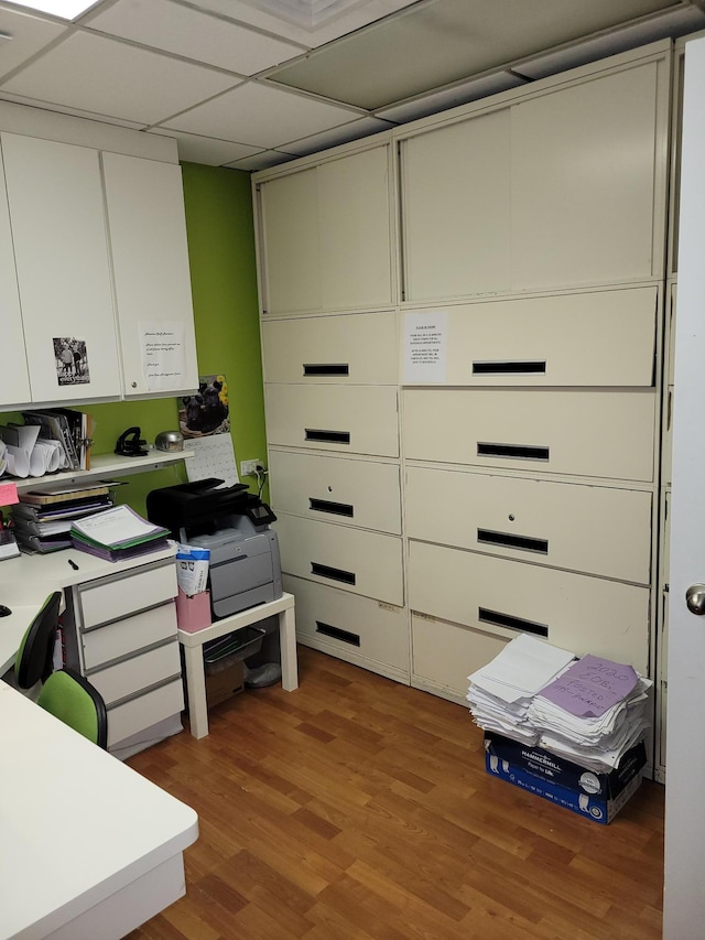 office featuring a paneled ceiling and light hardwood / wood-style floors