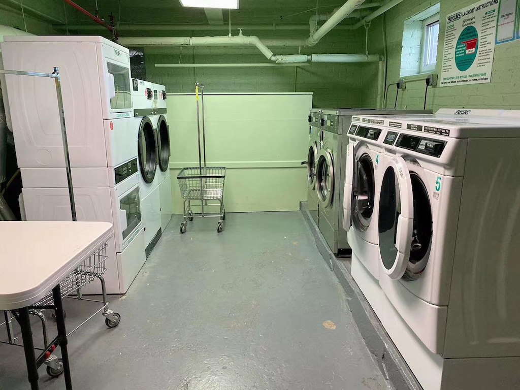 laundry room with washing machine and clothes dryer and stacked washer and clothes dryer