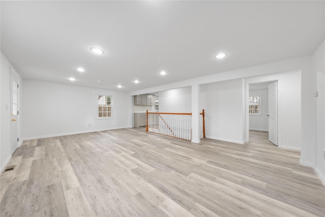 basement with light hardwood / wood-style flooring