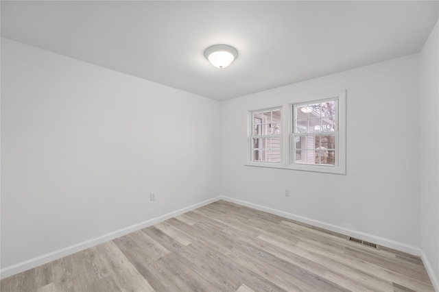 spare room featuring light wood-type flooring