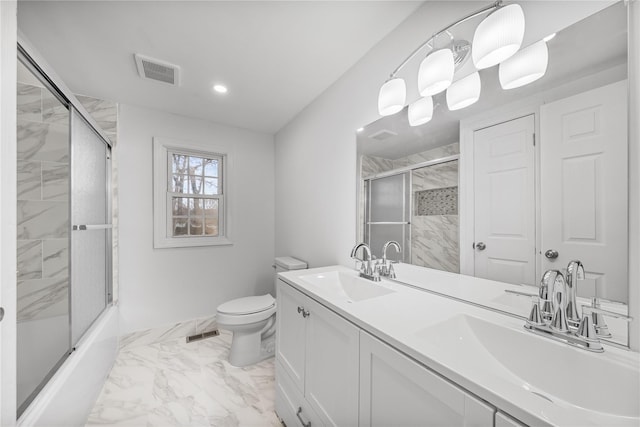 full bathroom featuring shower / bath combination with glass door, vanity, and toilet