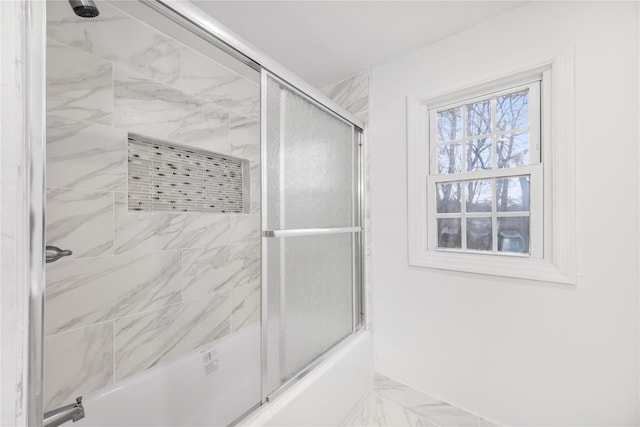 bathroom featuring shower / bath combination with glass door