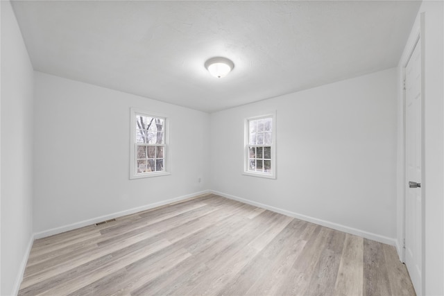 empty room with light hardwood / wood-style floors