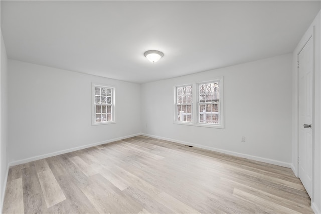 unfurnished room with light wood-type flooring