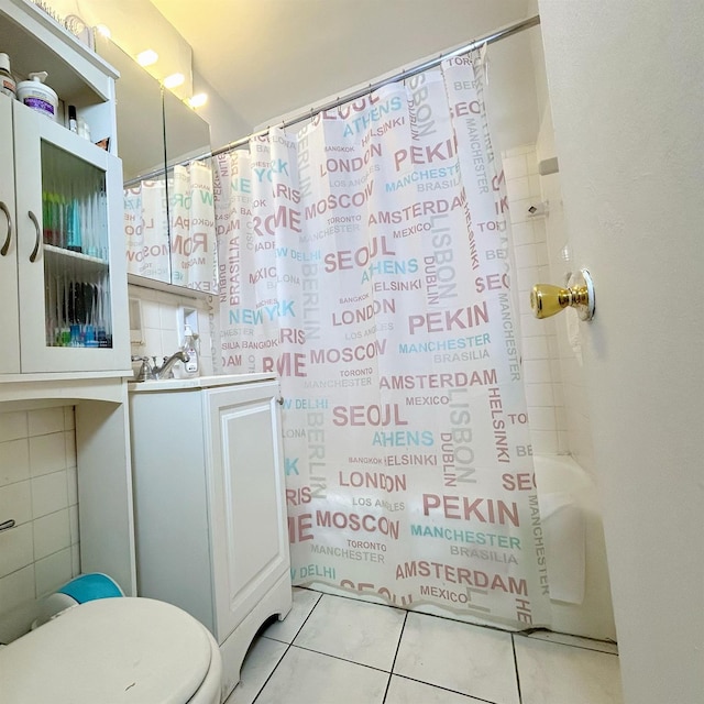 full bathroom with shower / tub combo, tile patterned floors, vanity, tile walls, and toilet