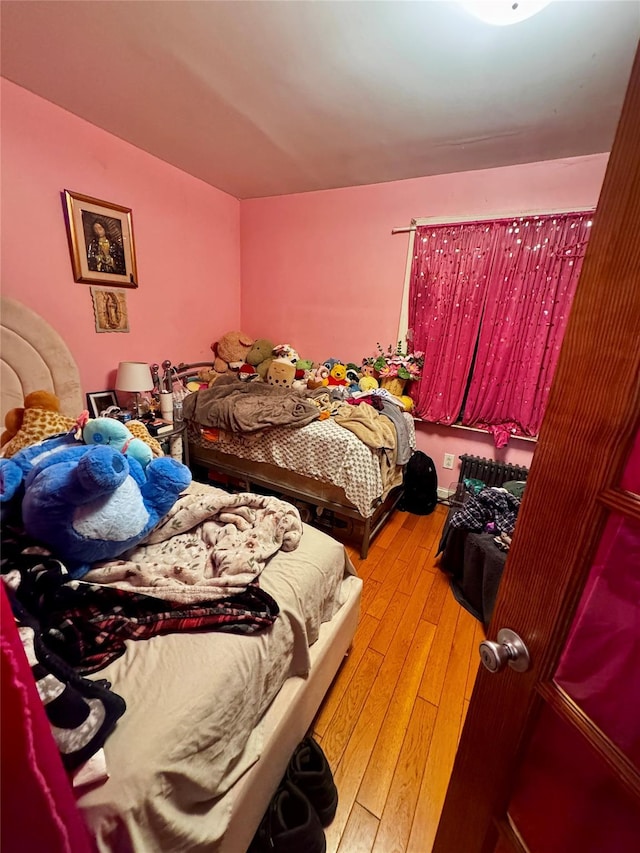 bedroom with wood-type flooring