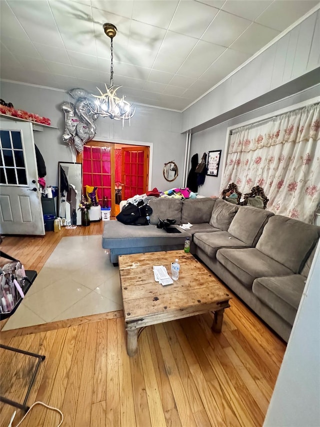 living room with wood-type flooring and a notable chandelier