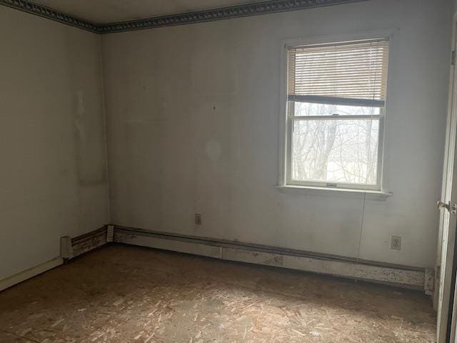 unfurnished room with baseboard heating