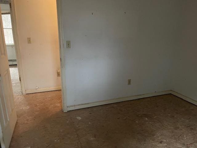 unfurnished room with baseboard heating