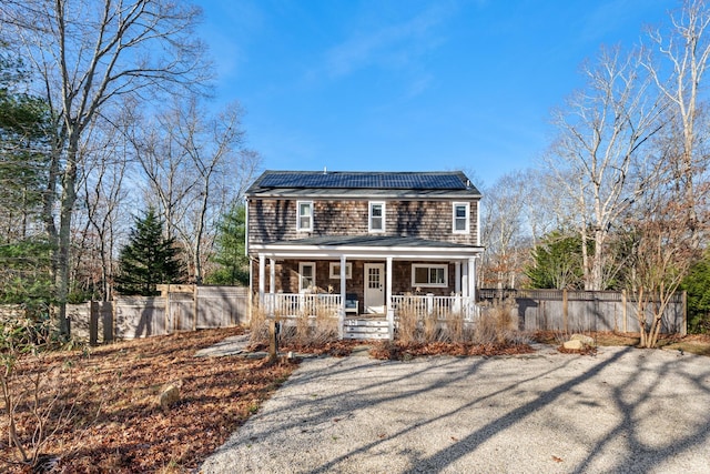 view of front of house featuring solar panels and a porch