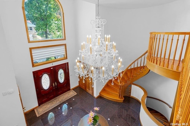 foyer with a high ceiling and an inviting chandelier