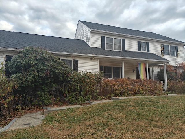 front of property with covered porch and a front lawn