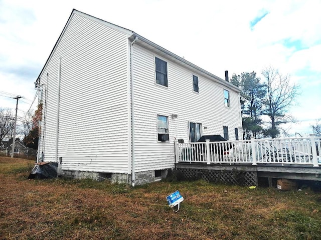 rear view of property with a wooden deck