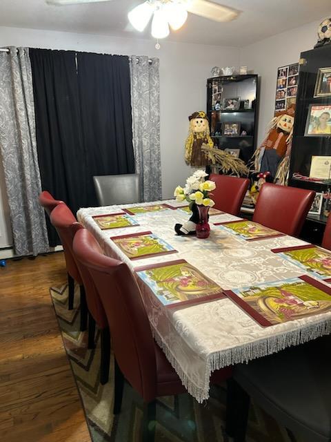 dining area with ceiling fan and dark hardwood / wood-style flooring