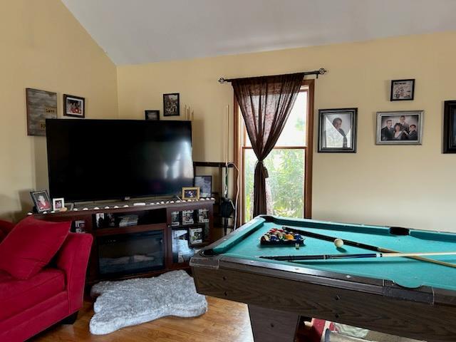 playroom featuring hardwood / wood-style flooring, vaulted ceiling, and pool table