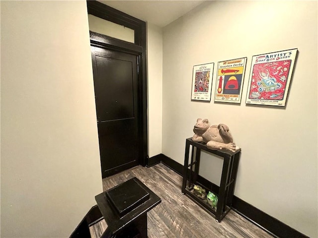 hallway with hardwood / wood-style floors