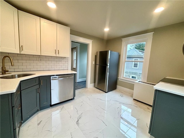 kitchen featuring white cabinetry, sink, and stainless steel appliances