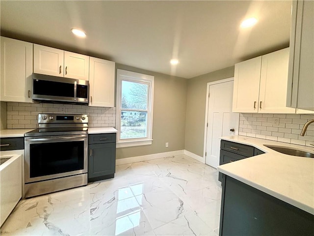 kitchen with white cabinetry, sink, and appliances with stainless steel finishes