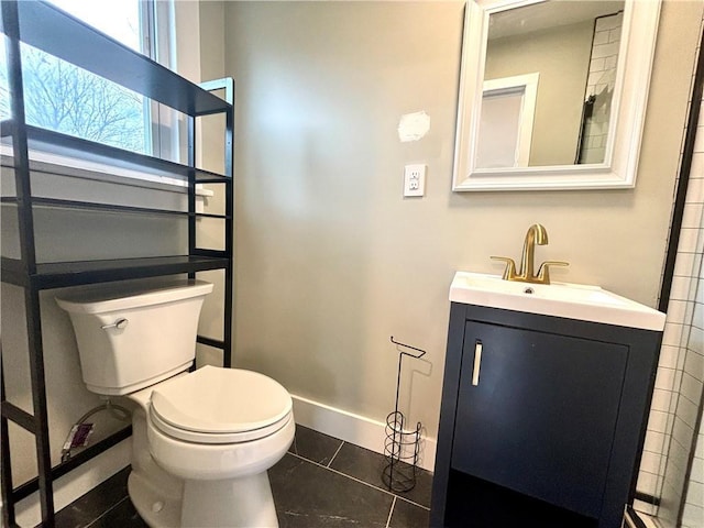 bathroom with tile patterned flooring, vanity, and toilet